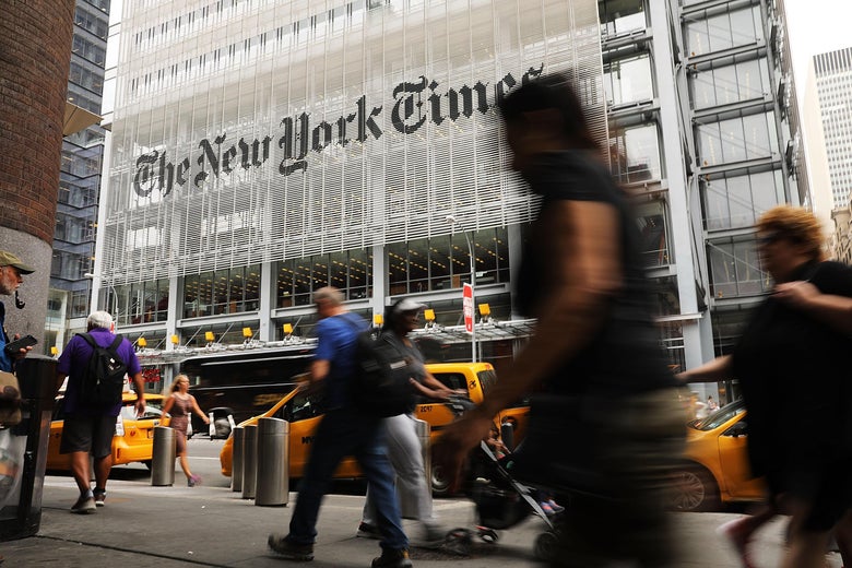People walk past the New York Times building in 2017.